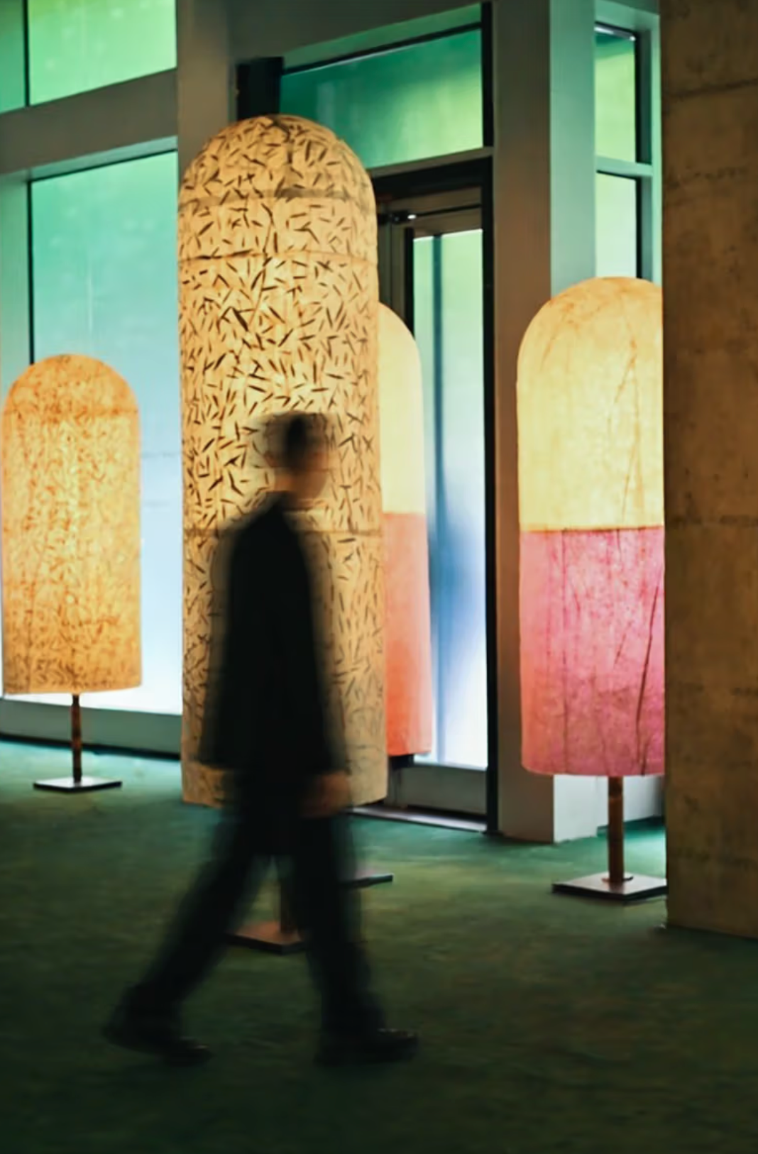 Handcrafted lamps made from bamboo and natural paper displayed in a minimalist gallery setting at Milan Design Week